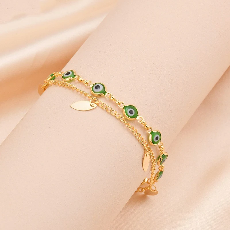 Pulseira dupla oval em aço titânio com banho de ouro 14K, design elegante e resistente, ideal para uso diário ou ocasiões especiais, adicionando sofisticação. — foto 7