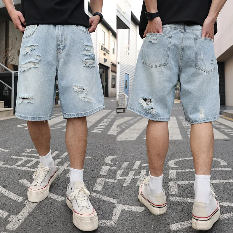 Ripped denim shorts, loose and casual, distressed details. These shorts offer a relaxed and stylish look, perfect for ev — photo 1
