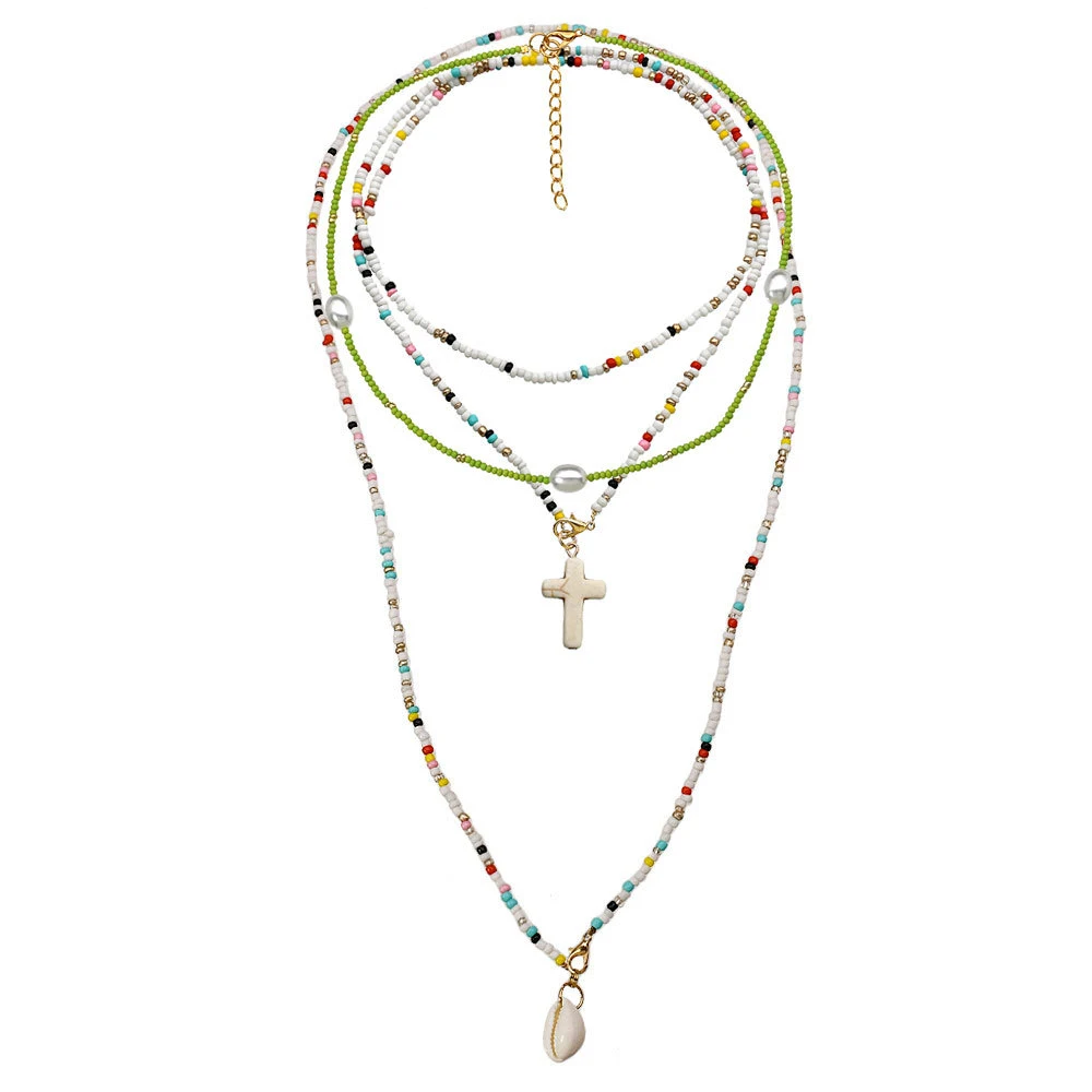 Colar artesanal com pingente de cruz de concha de camada dupla e contas de arroz pequenas coloridas, longo, um acessório elegante e versátil. — foto 10