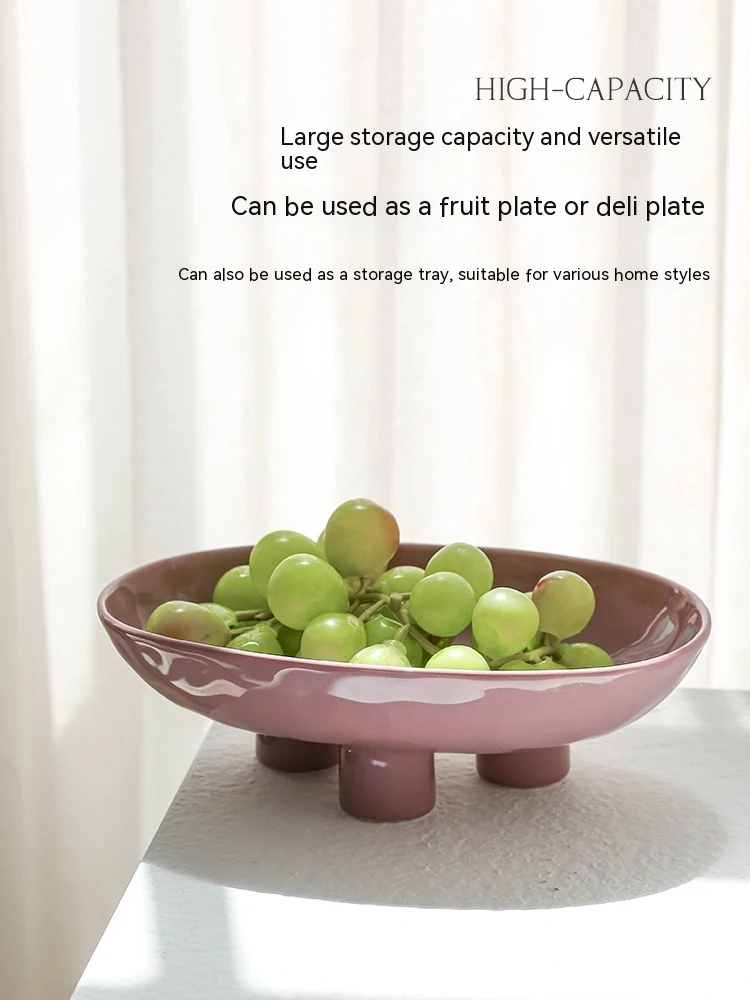 Handmade porcelain modern minimalist ceramic fruit plate with three feet, elevating fruit display and adding a touch of — photo 15