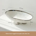 Handmade porcelain modern minimalist ceramic fruit plate with three feet, elevating fruit display and adding a touch of — photo 25