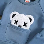 Conjunto infantil de duas peças, suéter branco com gola redonda e bordado de urso, perfeito para ocasiões especiais e conforto. — foto 1