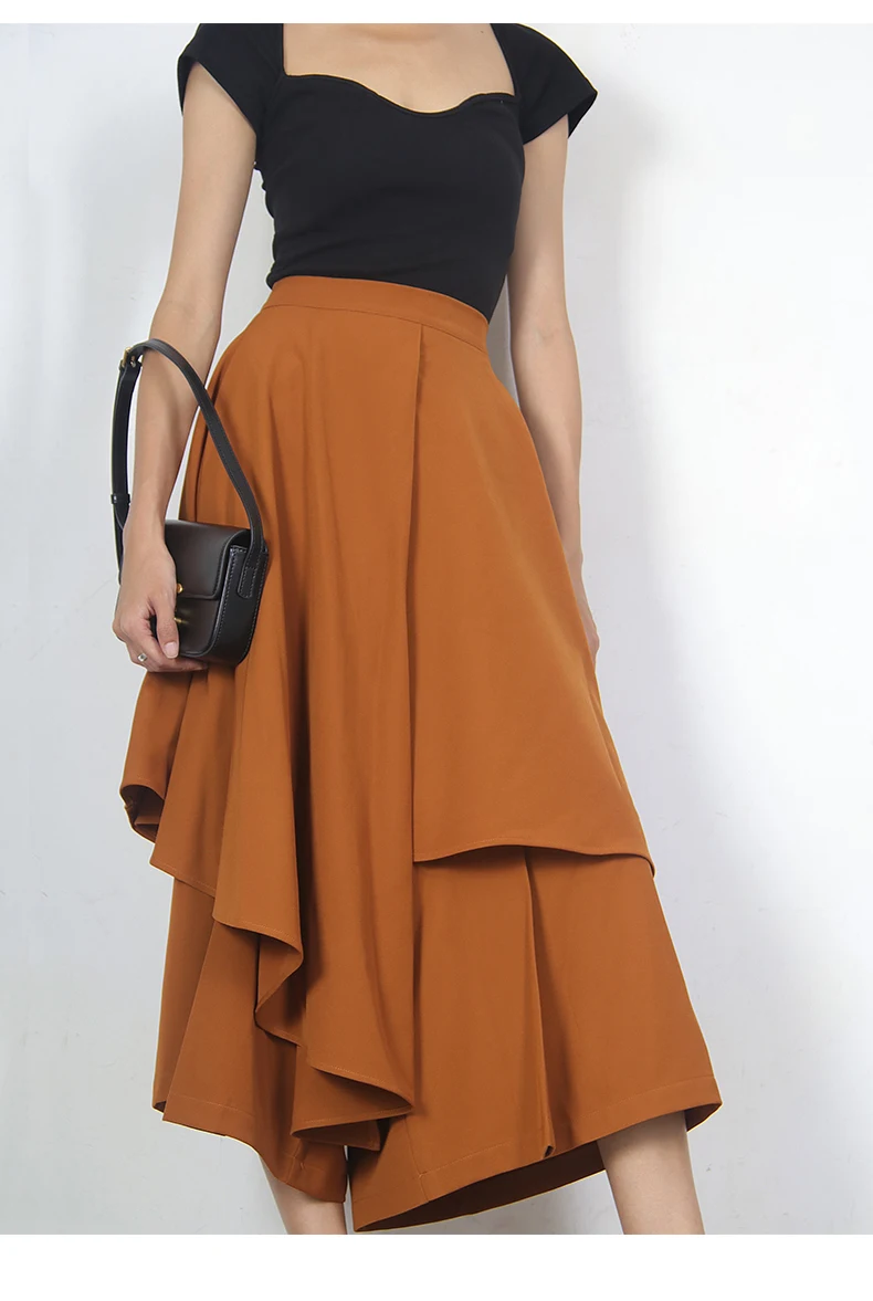 Saia feminina midi com babados e camadas irregulares. Um visual moderno e charmoso, ideal para diversas ocasiões e combinações. — foto 4