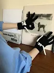 Hand Holding Gloves Black