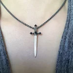 Colar cruzado de punhal feminino, um acessório ousado e elegante. Expresse sua fé com este colar único, perfeito para adicionar um toque de personalidade ao seu visual. — foto 7