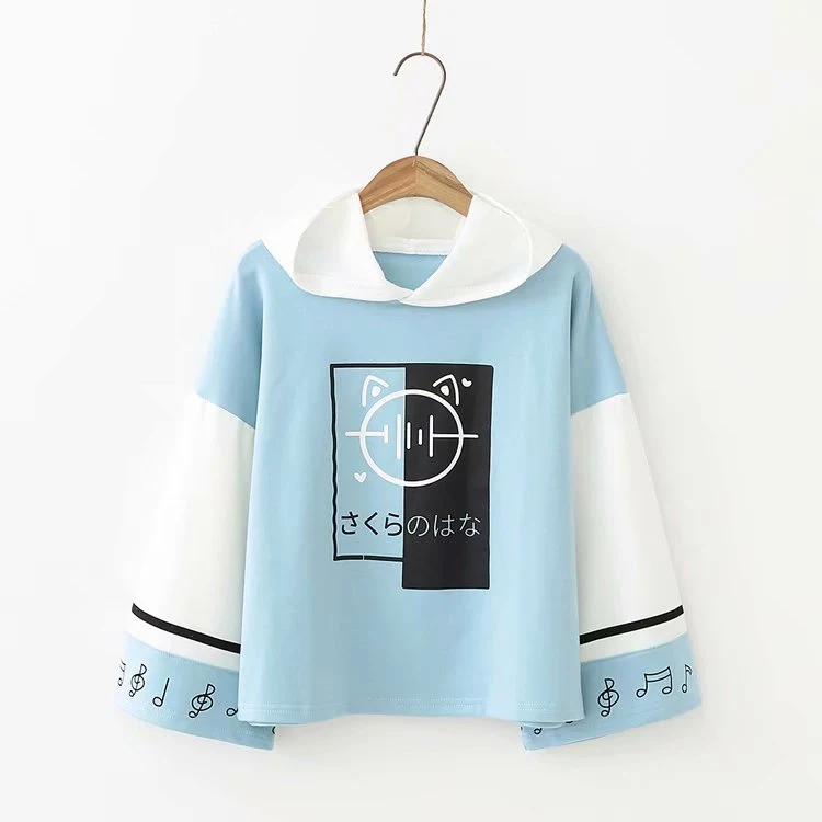 Maglione ampio a maniche lunghe con maniche a blocchi di colore e stampa di note, perfetto per un look casual e confortevole. — foto 2