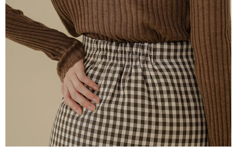 Title 8, Ladies mid-length plaid skirt offers timeless s...
