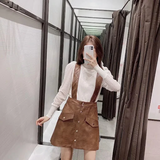 Title 5, Faux leather mini skirt with strap for a chic a...