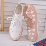 Small dirty orange canvas shoes perfect for a casual and vintage look. Comfortable and stylish, great for everyday wear. — photo 1