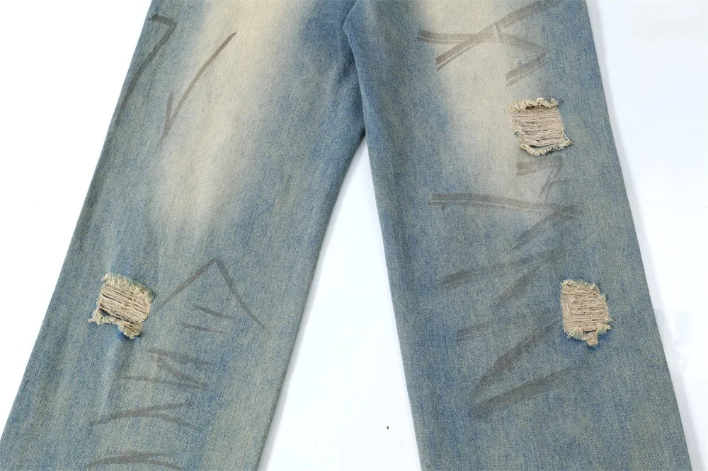 Graffiti distressed dirty ripped denim trousers for a bold urban look. Stylish and comfortable jeans, perfect for a mode — photo 19