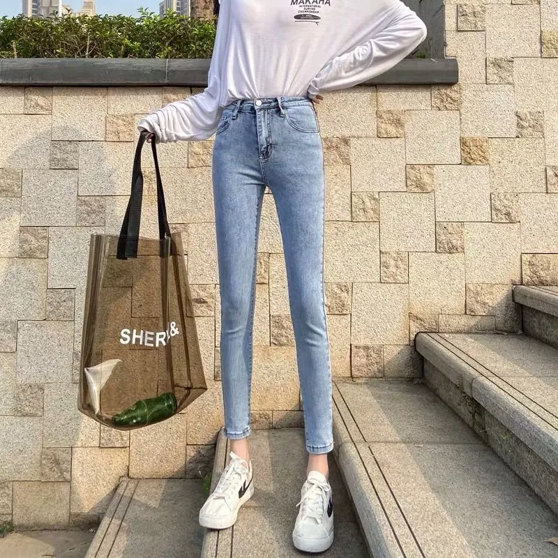 Women's light wash high-waisted slim fit stretch jeans. Tight-fitting ankle-length pencil pants for a flattering, modern — photo 4