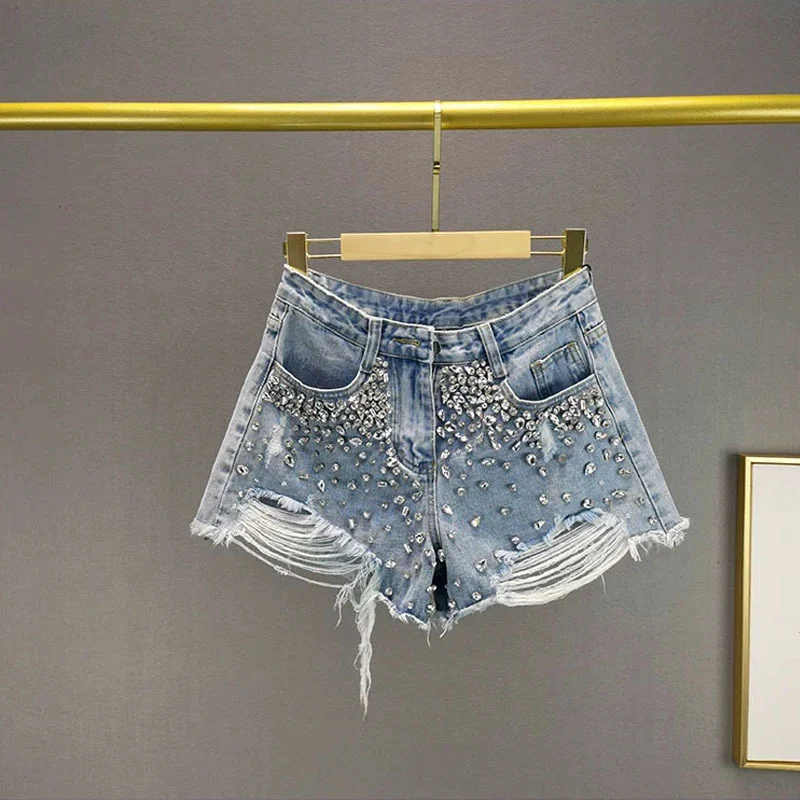 Dames denim shorts met wijde pijpen en gaten, ideaal voor de zomer. Comfortabel en trendy voor een casual en modieuze look. — foto 8