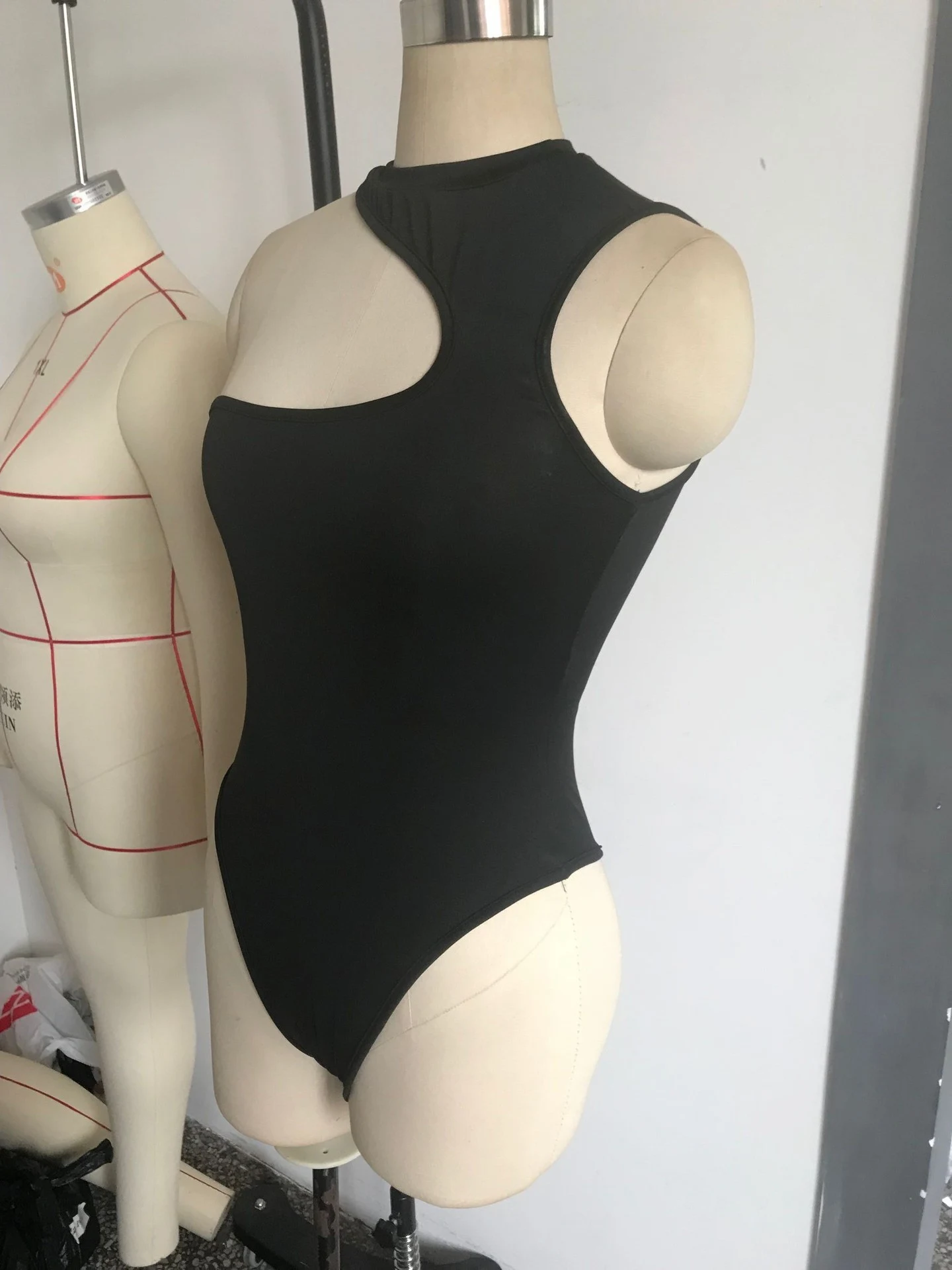 Title 11, Irregular slant shoulder hollow sleeveless body...