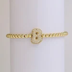 Pulseira de fio elástico com letras e zircônia Balloon Bubble 18K, joia fashion com contas de cobre, acessório charmoso. — foto 24