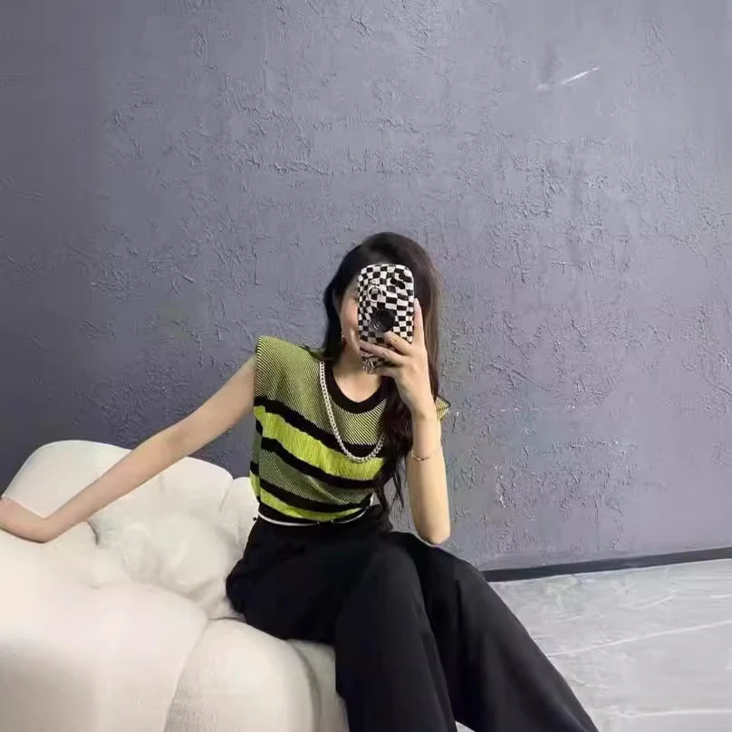 Striped contrast color knitwear vest top, perfect for layering and adding a stylish touch to your outfit. Comfortable, v — photo 1