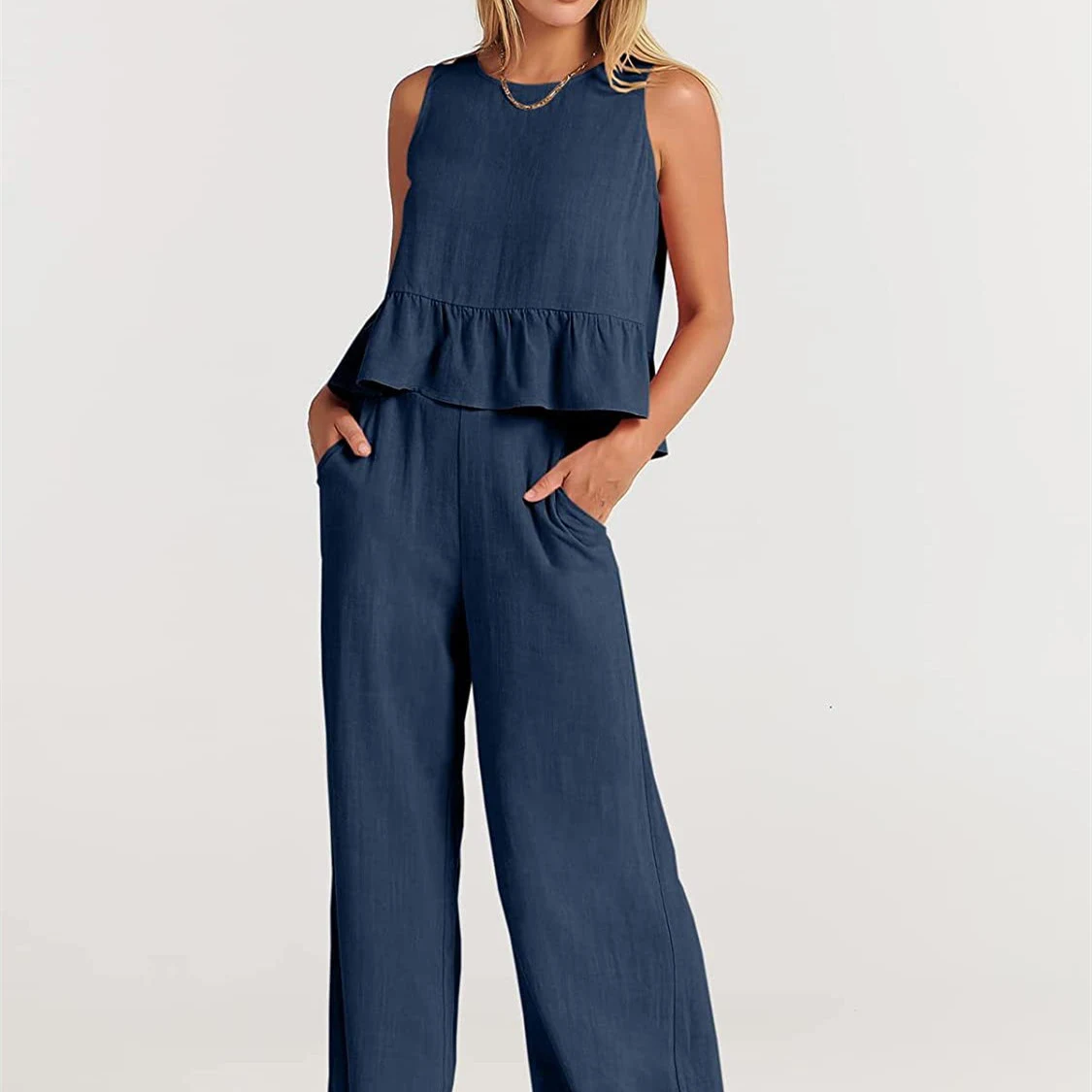 Conjunto feminino de calças amplas de nove quartos e blusa sem mangas com babados, moda e elegância para mulheres. — foto 1