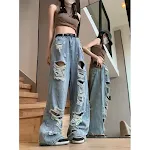 Calças jeans femininas rasgadas, boca larga, retrô e de tamanho grande. Estilo urbano e conforto para o dia a dia. — foto 11
